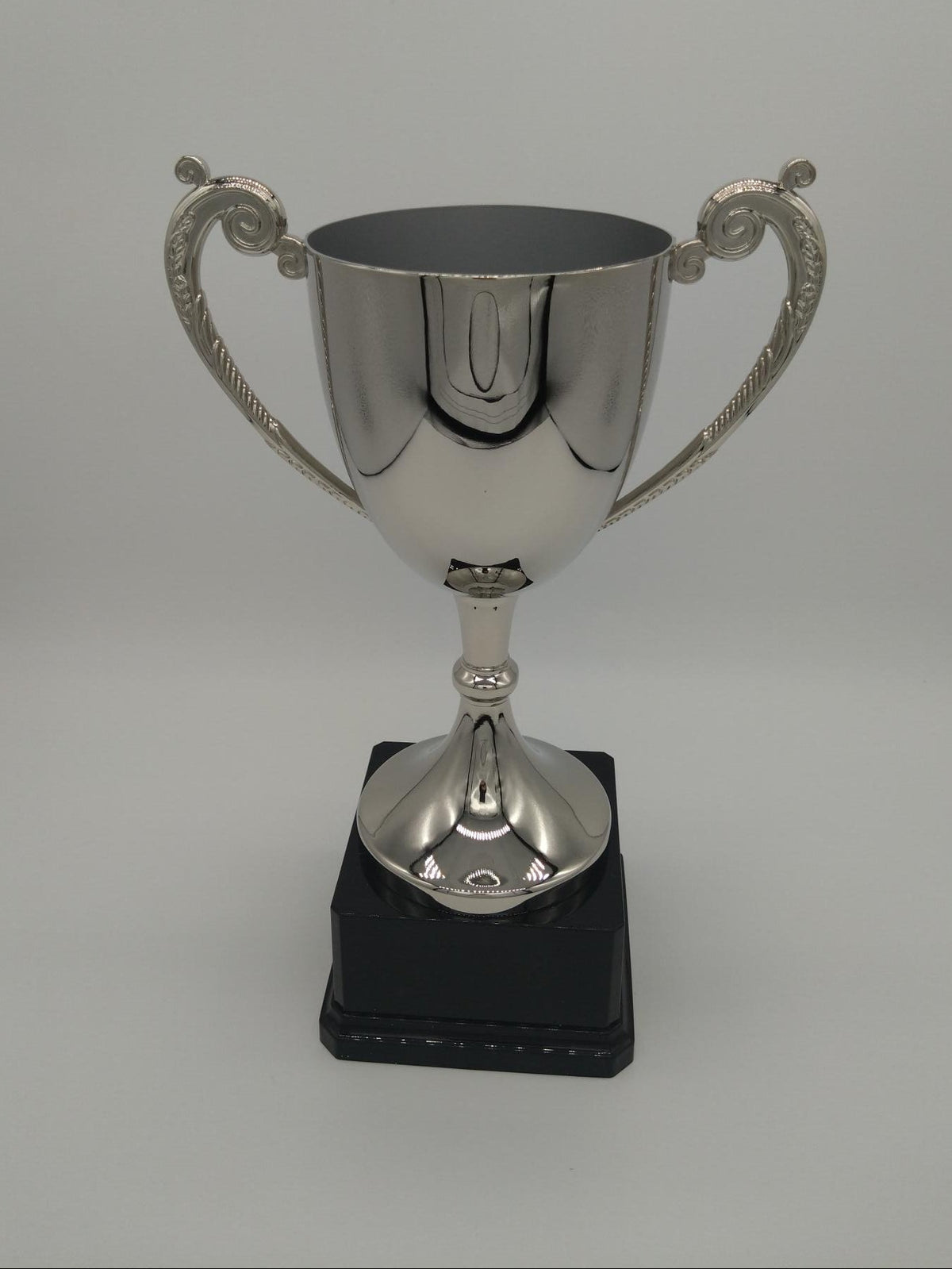 Silver trophy on a gray background