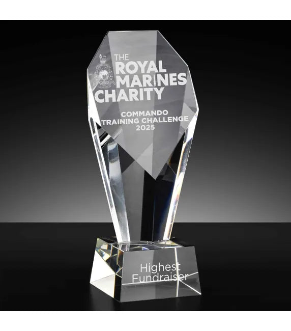 Crystal award with engraved text on a black background
