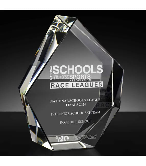 Crystal award with engraved text on a black background