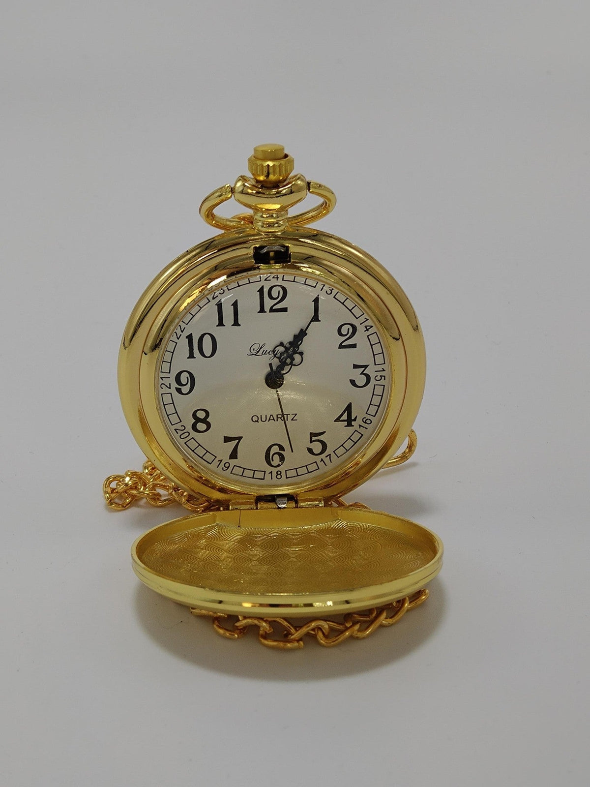 Gold plated pocket watch with arabic numbers on a white dial