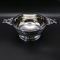 Silver quaich bowl with Celtic design on a black background