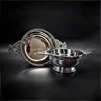Silver decorative bowl and platter on a black background