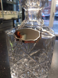 Stainless steel decanter label on crystal decanter in a shop
