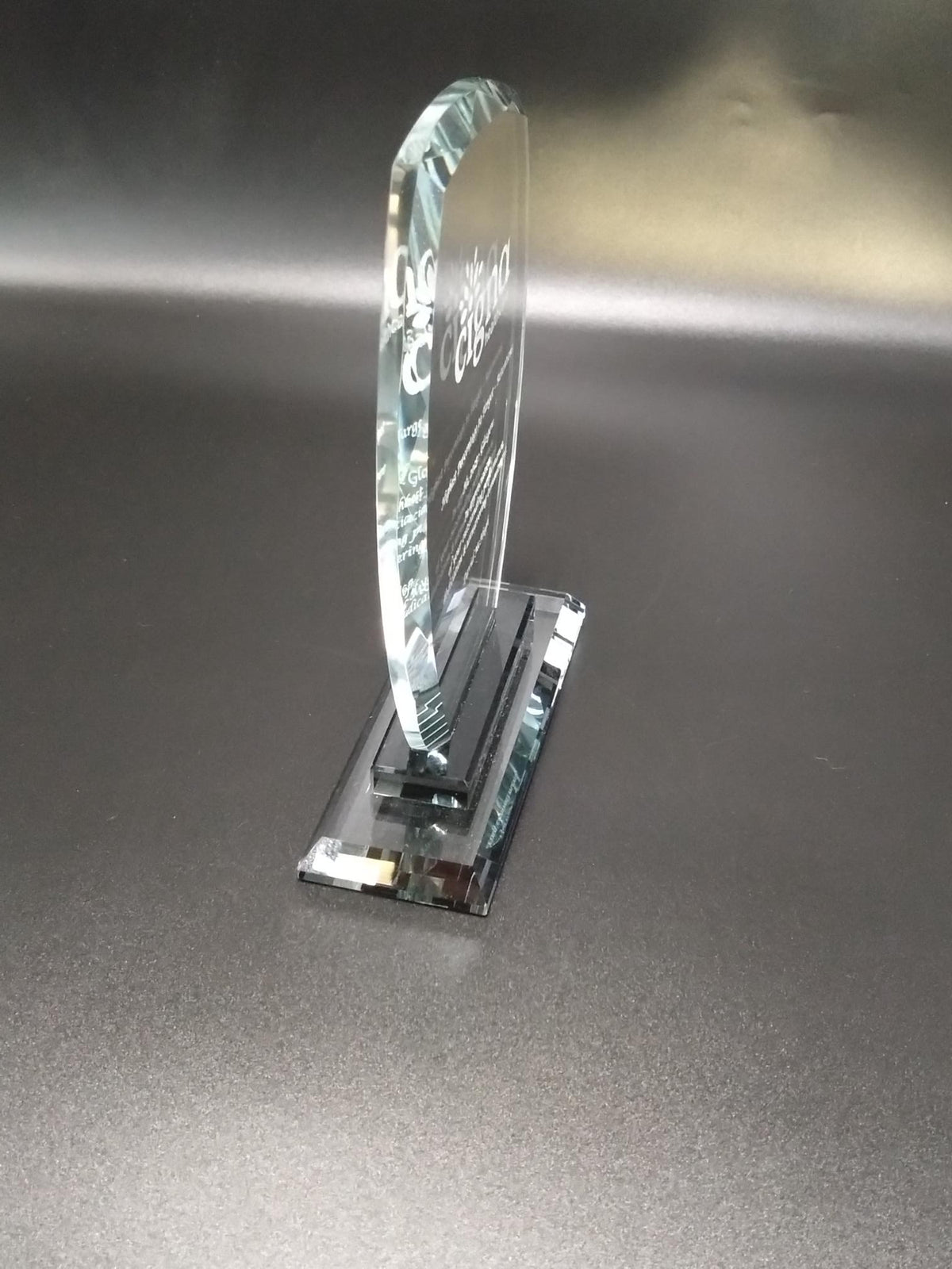 Glass object with engraved text on a metallic surface