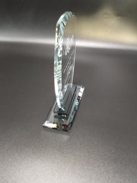 Glass object with engraved text on a metallic surface