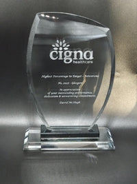 Glass award with Cigna Healthcare logo on a dark background