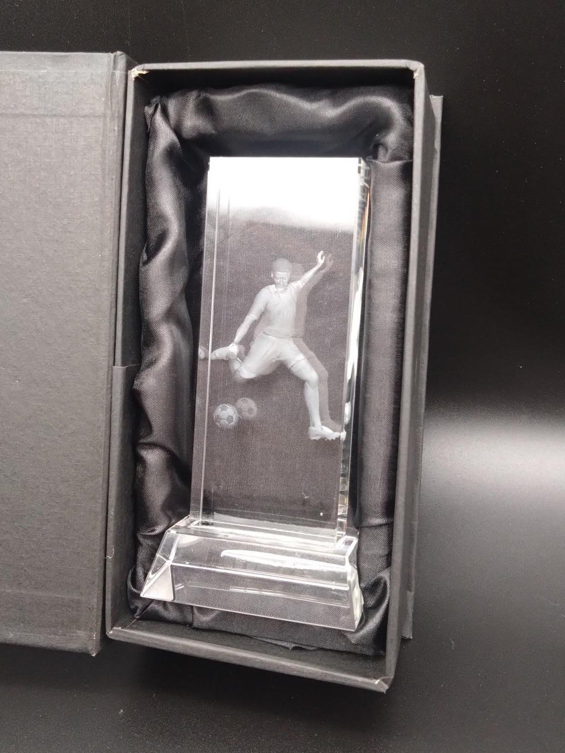 Glass football award in a black satin lined presentation box