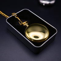 Gold pocket watch in a black box on a dark background