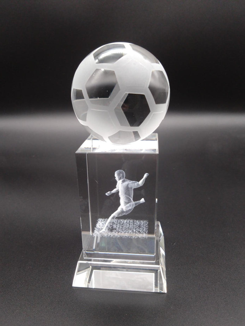 Crystal soccer ball and player figure on a dark background