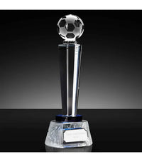Crystal trophy with a soccer ball on top against a black background