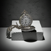 Vintage pocket watch on a stone surface with a dark background