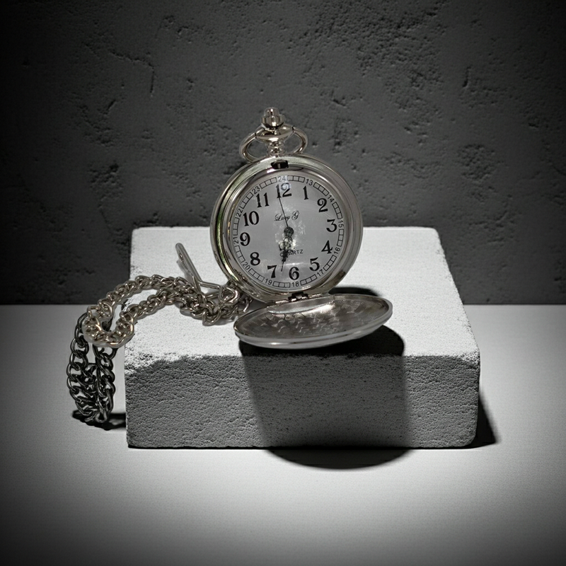 Vintage pocket watch on a stone surface with a dark background