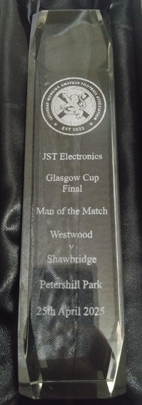 Crystal award with engraved text on a black background