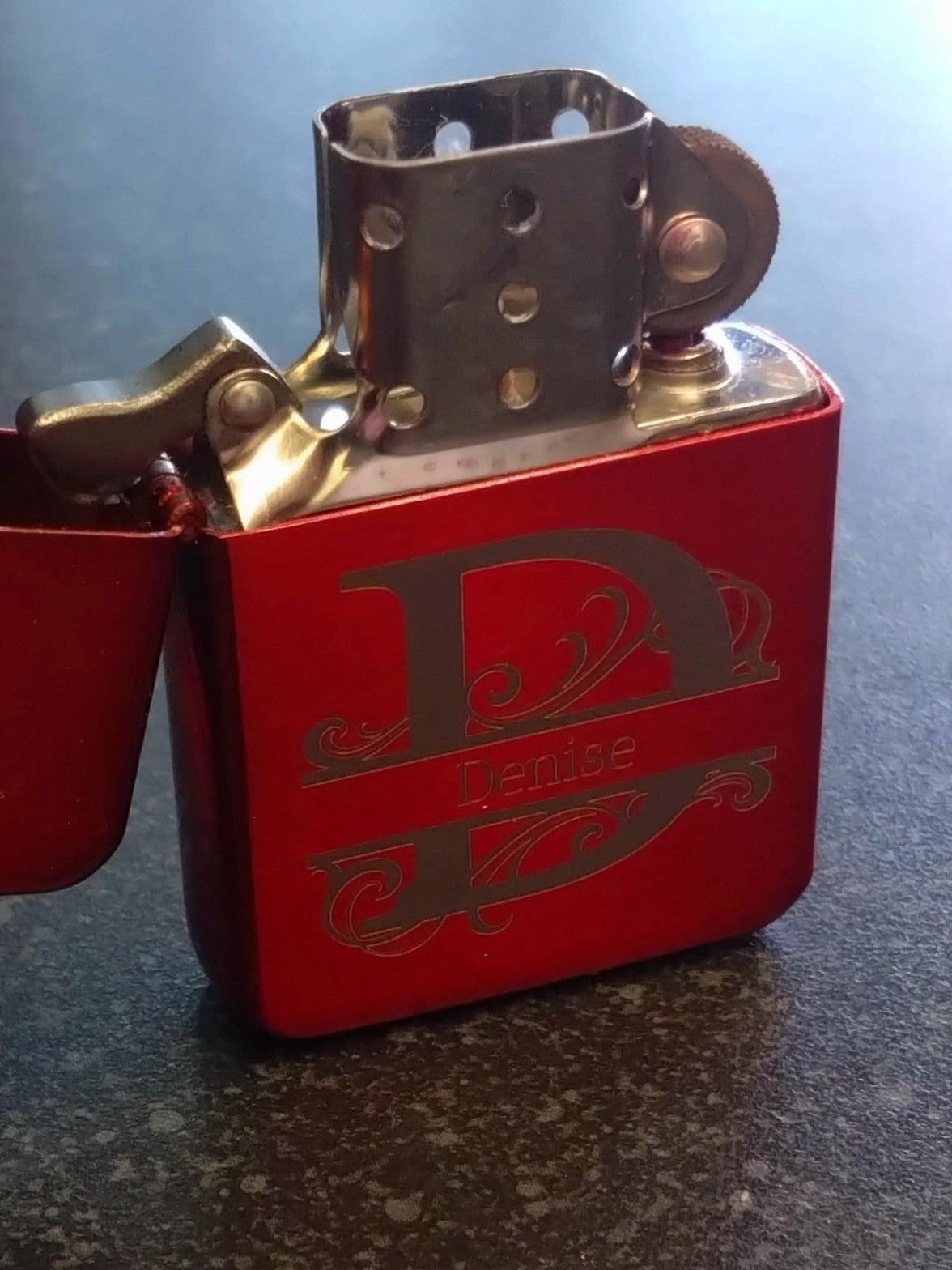 Red lighter with a brand logo on a dark surface