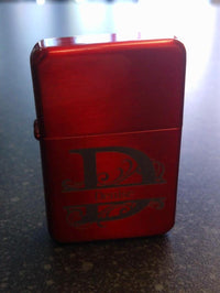 Red lighter with a logo on a dark surface
